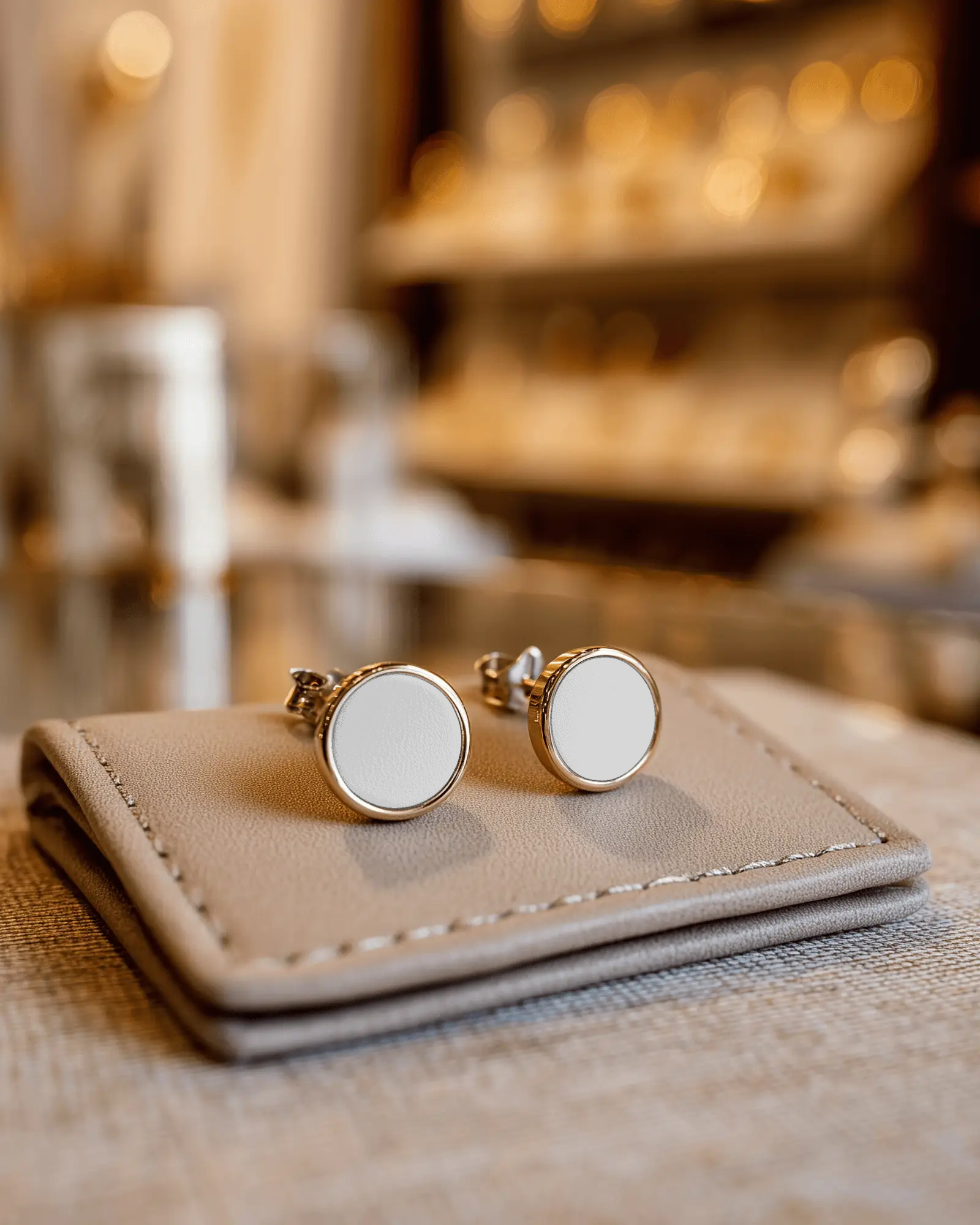 sleek-simple-circular-earring-mockup-on-leather-pad-for-modern-jewelry-designs
