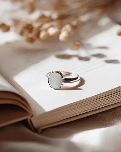 classic-round-ring-mockup-on-open-book-with-natural-light-shadow-effect-for-jewelry-design