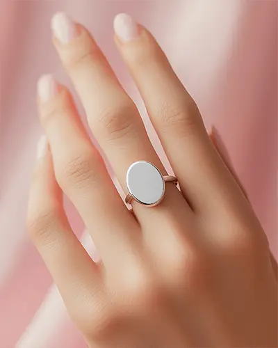 oval-face-ring-mockup-on-female-hand-soft-pink-background-elegant-closeup-golden-metal-minimal-look