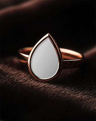 teardrop-cut-ring-mockup-placed-on-soft-brown-velvet-surface-closeup-of-golden-band-and-clear-faceted