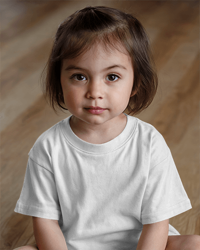 Adorable Kid T Shirt Mockup Little Girl In Bright Green Tee Sitting On Wooden Floor With Curious Expression Casual And Cute Look