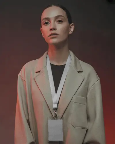 Bold Id Card Lanyard Mockup Featuring Female Model In Neutral Jacket Against Moody Backdrop