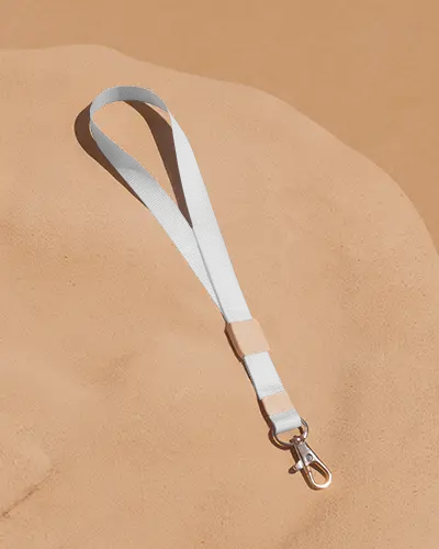 Elegant Lanyard Mockup On Warm Sand Surface With Metal Clip And Clean Flat Lay