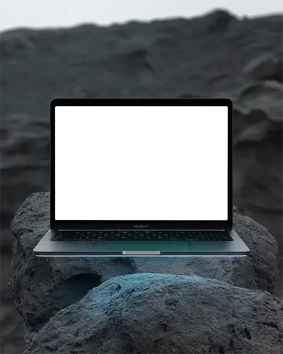 Macbook Air M1 Mockup Floating Over Porous Volcanic Rocks With Subtle Blue Underglow And Dusk Horizon Moody And Natural Scene