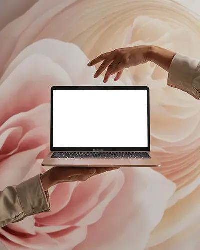 Macbook Air M1 Mockup Held In Hands With Abstract Rose Blossom Background And Elegant Light