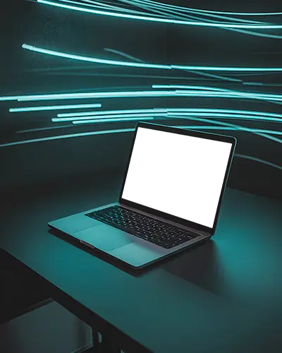 Macbook Pro M1 Mockup On Dark Desk With Electric Blue Light Trails In Modern Studio