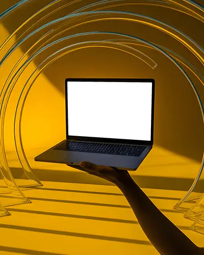 Macbook Pro M1 Mockup Held In Hand With Clear Arches And Yellow Backdrop Light Play