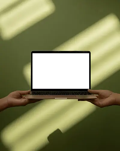 Macbook M1 Pro Mockup Held By Two Hands Against Green Wall With Soft Sunlight Stripes