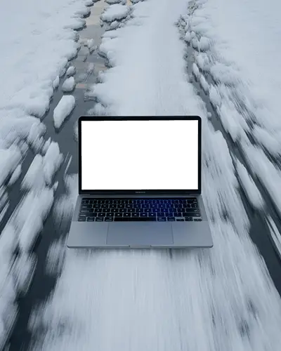 Winter Road Macbook Air M1 Mockup Placed On Snowy Path With Motion Blur And Frozen Scenic Vibes