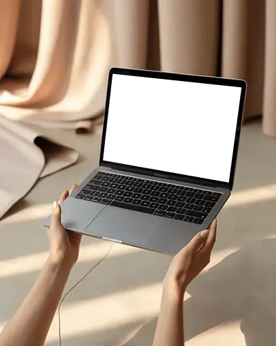 Hands Holding Macbook Air M1 Mockup In Soft Sunlight With Curtains And Warm Floor