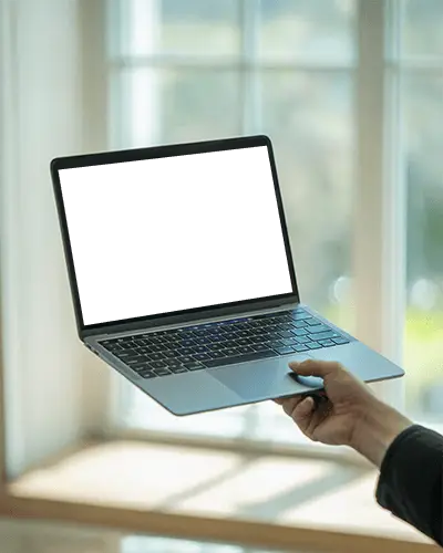 Macbook Pro M1 Mockup Held By Hand In Front Of Bright Window With Soft Daylight Glow