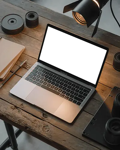 Rustic Wood Desk Macbook Air M1 Mockup Surrounded By Camera Gear And Soft Light