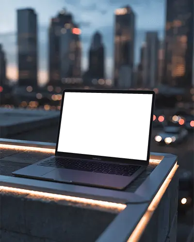 Macbook Air M1 Mockup On Rooftop Edge With City Skyline Bokeh Lights In Evening Ambience