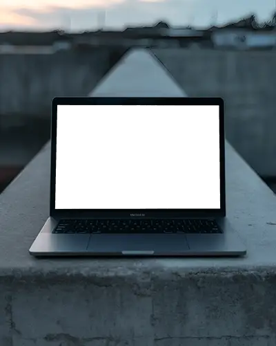 minimalist-mockup-of-macbook-air-m1-on-sunset-lit-wall-in-quiet-cityscape-environment