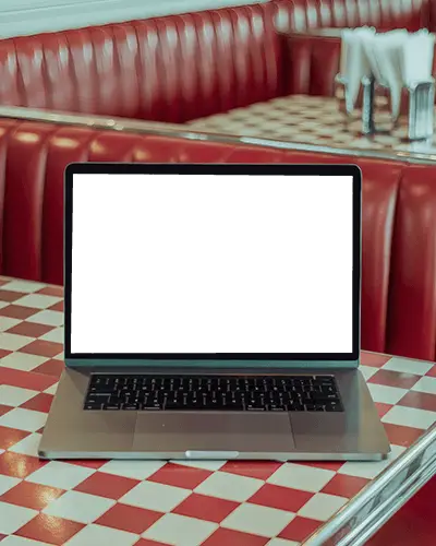retro-american-diner-scene-with-macbook-pro-m1-on-tiled-table-and-classic-red-interior
