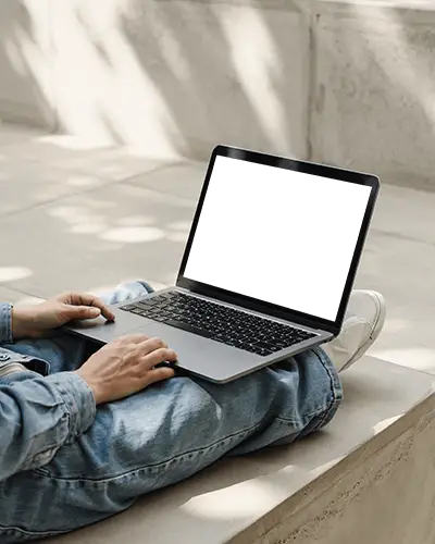 macbook-m1-pro-mockup-on-lap-in-sunlit-concrete-space-with-denim-outfit-and-soft-shadows