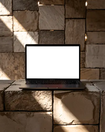 M1 Air Mockup On Rustic Stone Block In Warm Sunlight With Textured Wall And Soft Shadows