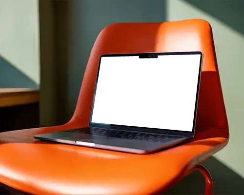 Macbook M2 Pro Mockup On Bold Orange Chair With Strong Sunlight And Modern Interior Style