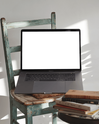 Macbook Pro On Desk With Orange Card Background And Soft Shadows For A Creative Studio Vibe