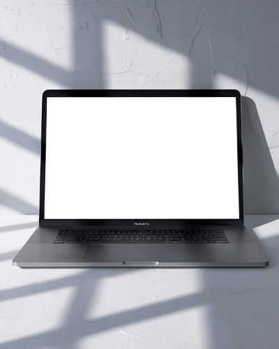 Macbook Air M2 Placed On White Surface With Sunlit Shadows Casting Geometric Patterns For A Stylish Minimalist Look