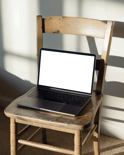 Macbook Air M2 On Rustic Wooden Chair With Warm Sunlight Casting Shadows For A Cozy Natural Background Highlight