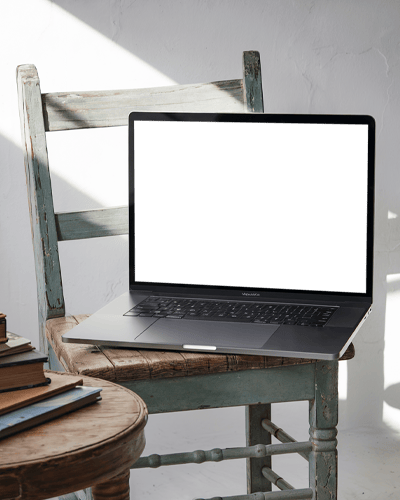 Macbook Pro M1 Placed On Vintage Wooden Chair Bathed In Soft Sunlight Showcasing Design In A Rustic And Inviting Setting