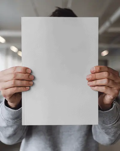 Minimal Studio Magazine Mockup Man In Grey Sweatshirt Presenting Front Facing Cover