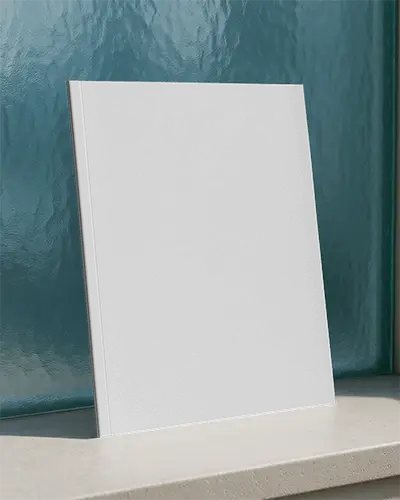 Sunlit Outdoor Magazine Mockup Leaning Against Textured Blue Glass Panel On Stone Surface With Natural Light 0209