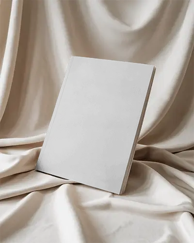 Elegant Upright Magazine Mockup Standing On Soft Beige Draped Fabric With Gentle Natural Lighting 0221