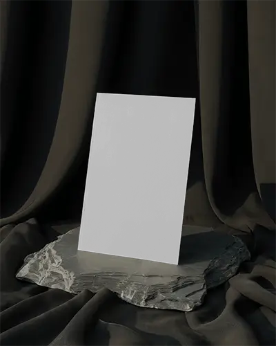 Upright Magazine Mockup On Rough Stone Slab With Draped Dark Fabric Background And Dramatic Light 0224