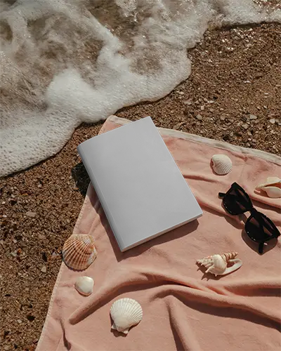 Beachside Editorial Magazine Mockup Closed Cover On Sand With Seashells And Sunglasses Near Ocean Waves For Summer Brand Presentation 0310