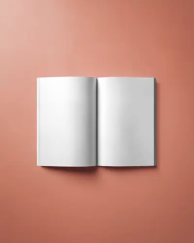 Open Magazine Laying Flat On Coral Background With Smooth Light Reflection Texture