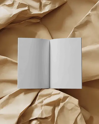 open-magazine-mockup-on-crumpled-brown-paper-textured-backdrop-top-view-layout