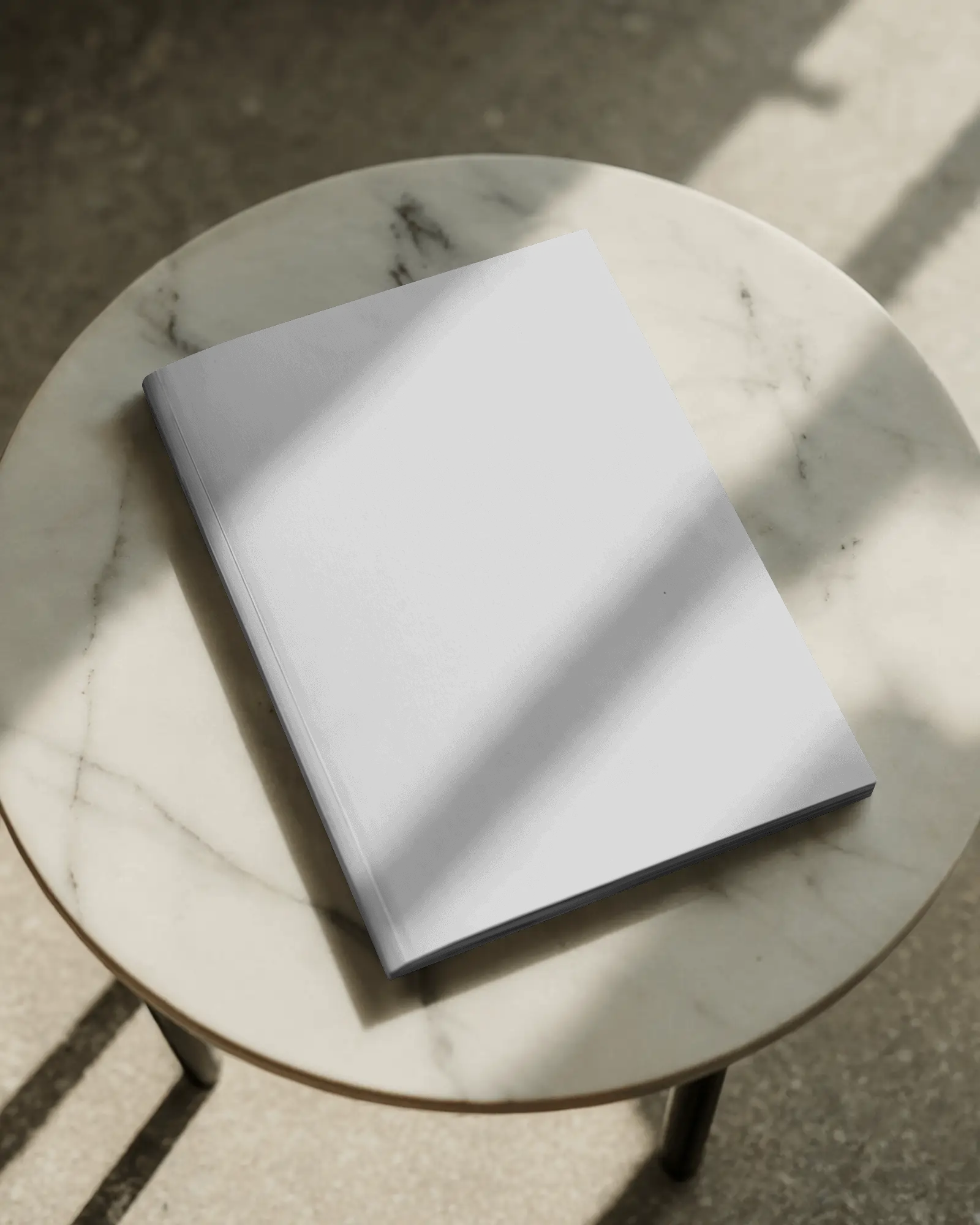 angled-magazine-mockup-on-white-marble-table-with-natural-shadow-premium-styling