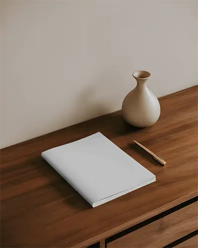 clean-magazine-mockup-layout-on-wood-surface-with-pen-and-decorative-vase