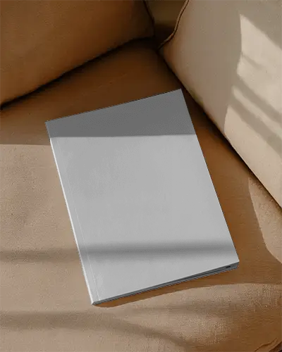 hardcover-magazine-mockup-on-cushioned-sofa-for-branding-presentation-neat-showcase