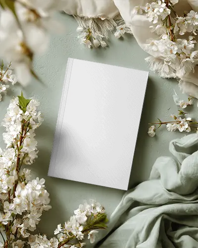 Blank Hardcover Magazine Mockup Surrounded By Floral Elements And Fabric Texture Background