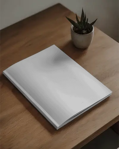 Premium Print Magazine Mockup Placed On Textured Wood Surface With Simple Plant Decor