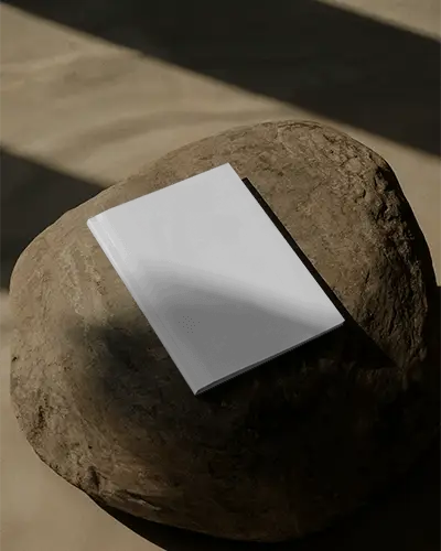 Hardcover Magazine Mockup On Natural Stone In Shadowed Environment For Design