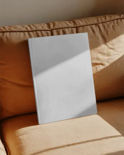 Elegant Blank Magazine Mockup Placed On Soft Cushioned Surface With Natural Light Effect