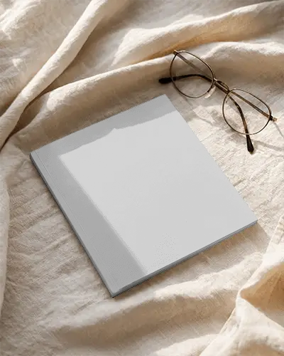 Minimalistic Square Magazine Mockup With Folded Fabric And Reading Glasses For Design