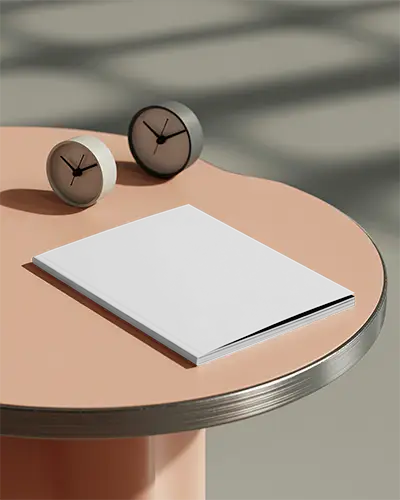 Minimalist Hardcover Magazine Mockup Placed On Round Table With Two Clocks