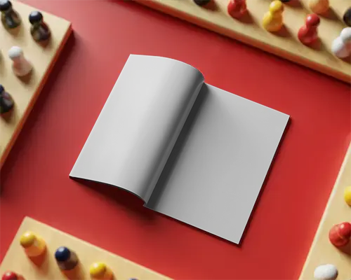 Open Magazine Mockup On Tabletop Surrounded By Game Pieces For Design Presentation