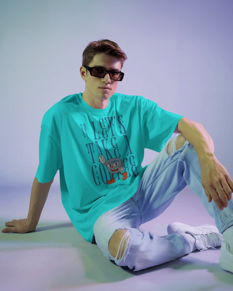 Retro Casual T Shirt Mockup Male Model Sitting In Vibrant Studio Lighting