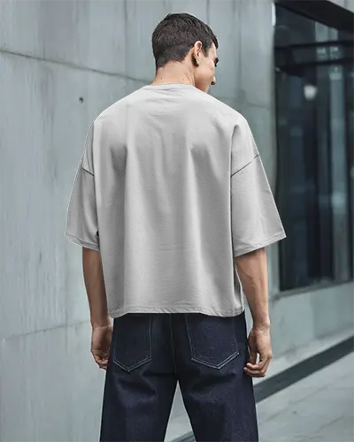 Urban Back View T Shirt Mockup Male Model In Boxy White Tee And Dark Denim Modern City Setting Clean Streetwear Look
