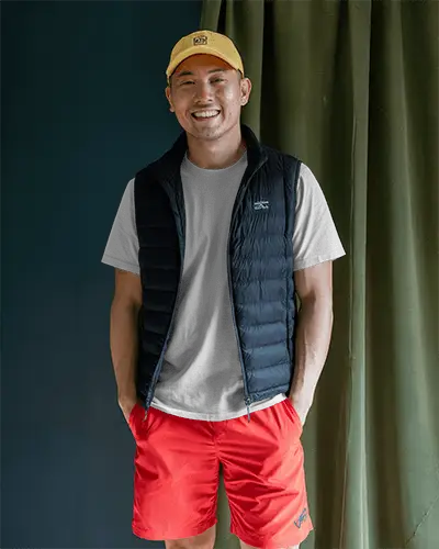 White Tshirt Mockup On Smiling Male Model Yellow Cap Red Shorts Navy Vest Casual Athleisure Style Template