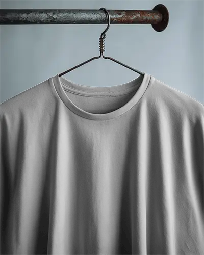 White Tshirt Mockup On Vintage Wire Hanger Industrial Metal Rod Closeup Front View Soft Shadow Lighting