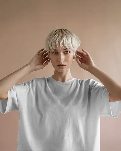 Front View Tshirt Mockup Platinum Blonde Model Hands Near Face Soft Peach Background Minimal Style