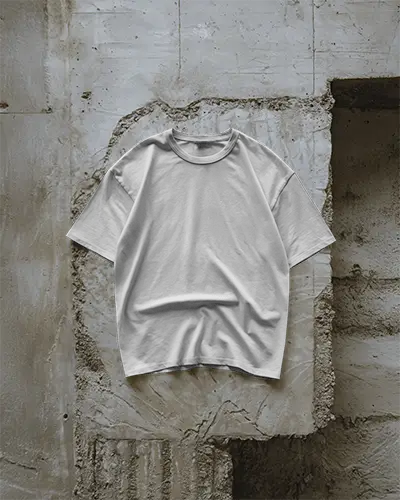 Boxy Tshirt Mockup Hanging On Textured Concrete Wall Industrial Style Natural Light Apparel Template