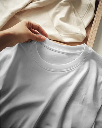 Close Up Tshirt Mockup White Shirt With Hand Detail And Cream Fabric Backdrop